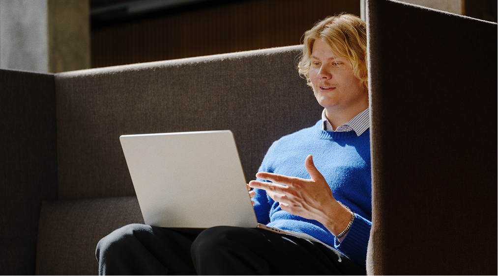 Person working with laptops in sofa